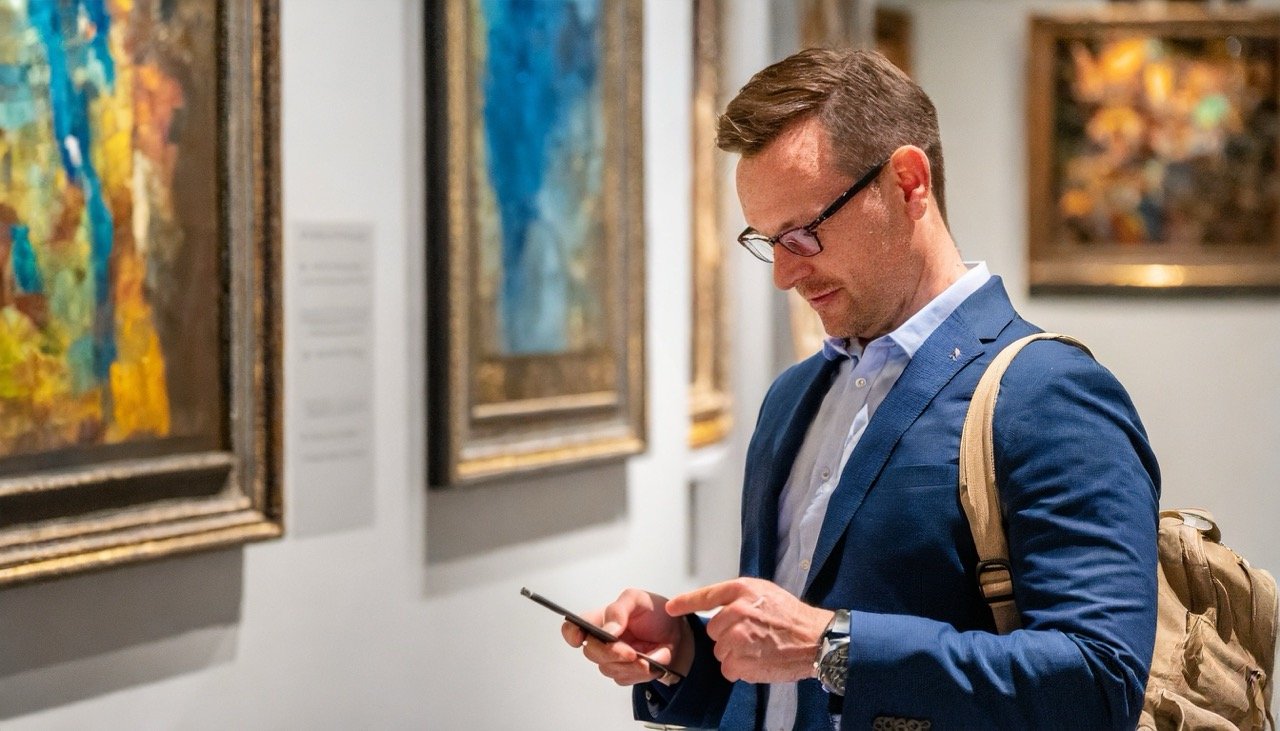 Smartphone with museum app open, showing an interactive audio tour